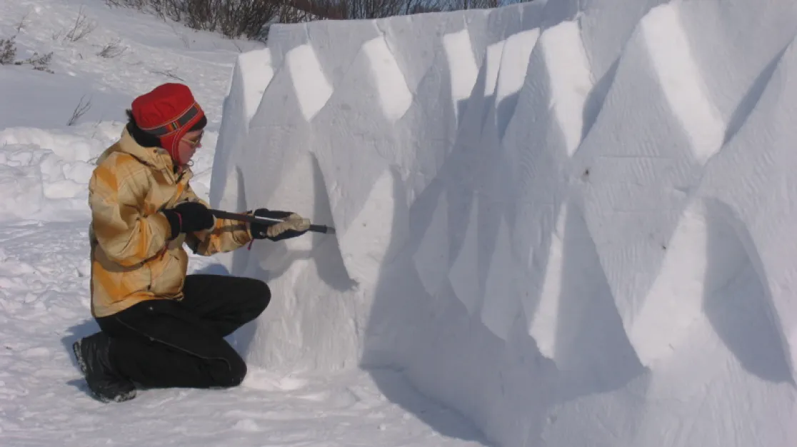 Saami girl carving snow-art.